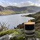 Lit scented candle with view