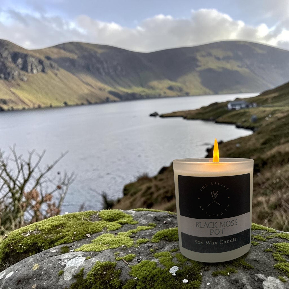 Lit scented candle with view