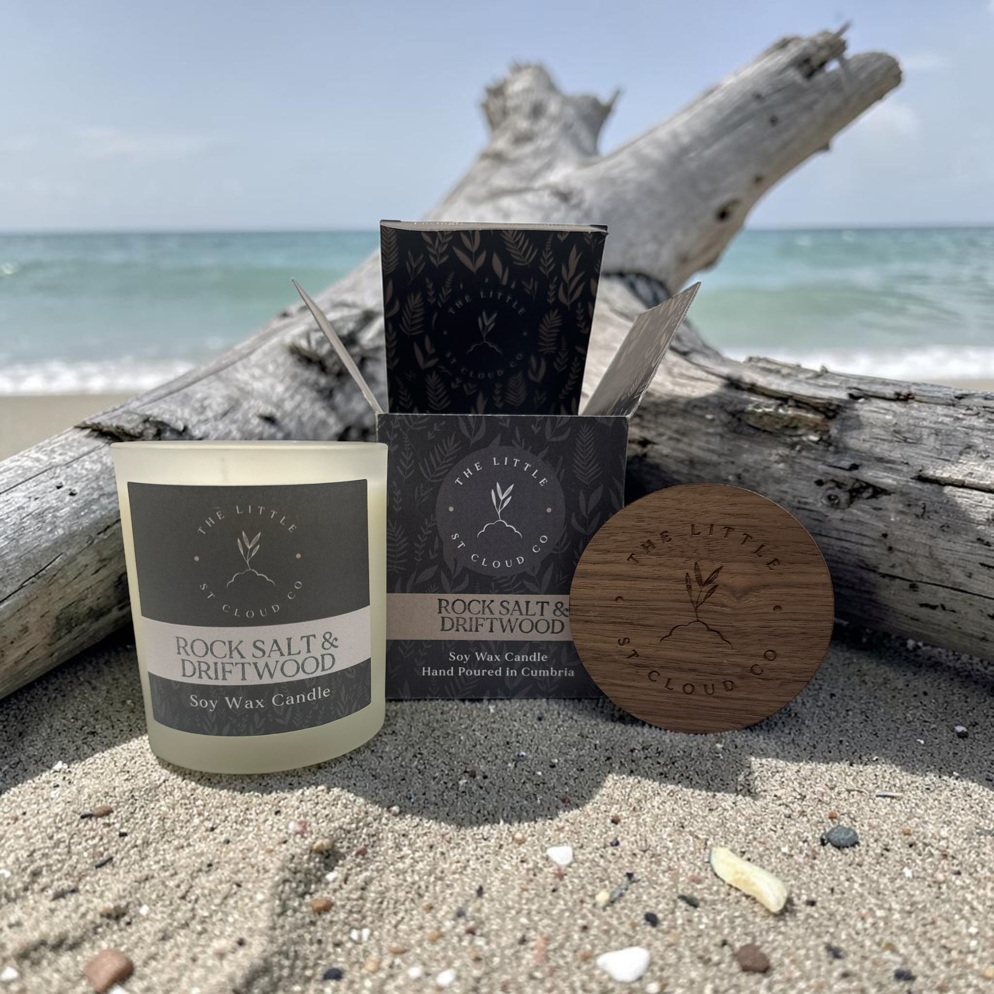 Candle and packaging on a beach