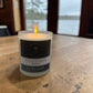 a lit frosted candle jar by the little st cloud co in the scent windermere mist with lake views
