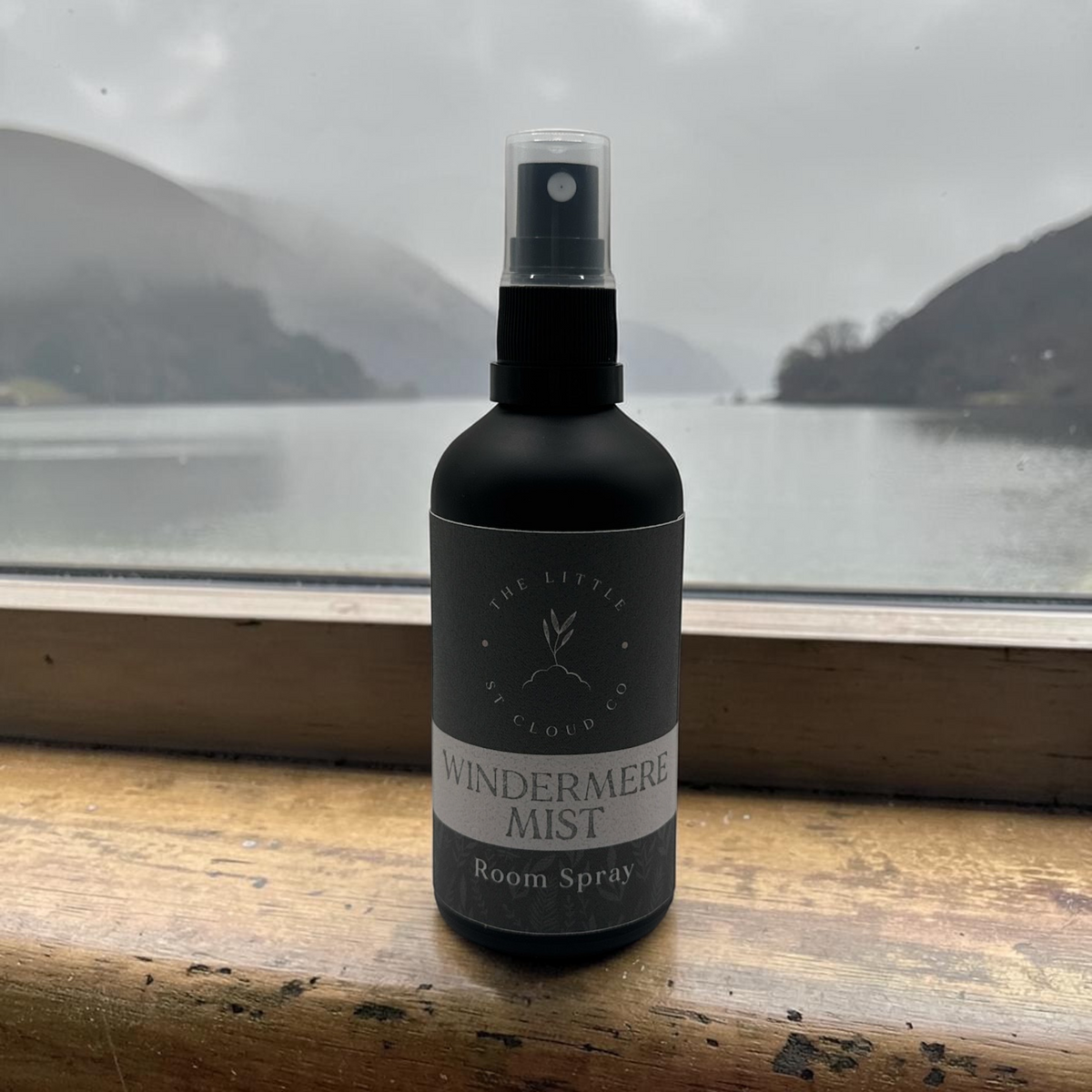 a matte black bottle of room spray by the little st cloud co in the scent windermere mist with lake views