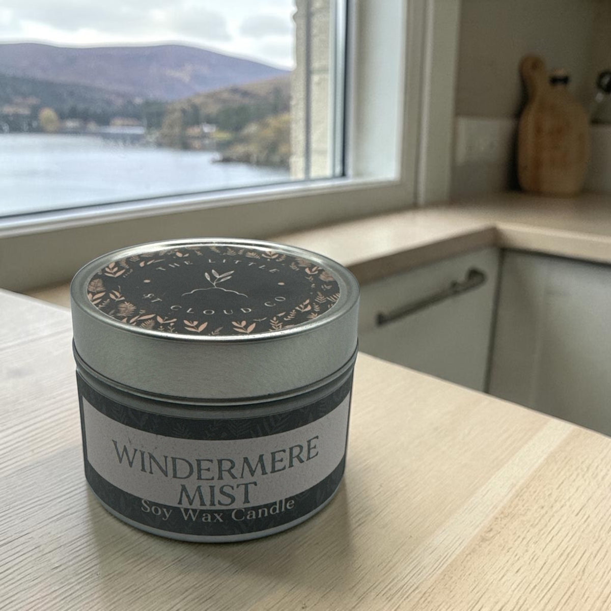  a silver candle tin by the little st cloud co in the scent windermere mist in a bright kitchen with lake views