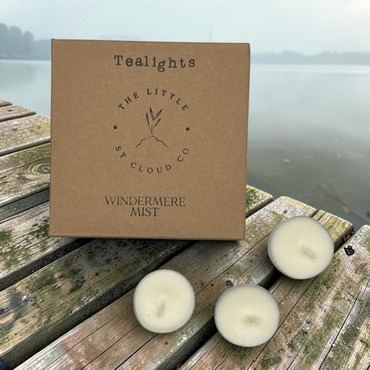 a kraft box and 3 tealights by the little st cloud company in the scent windermere mist on a wooden jetty on a misty lake