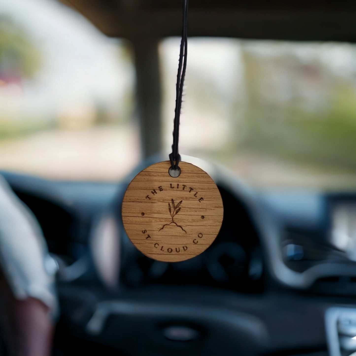 Wooden Air freshener hanging from a rear view mirror 